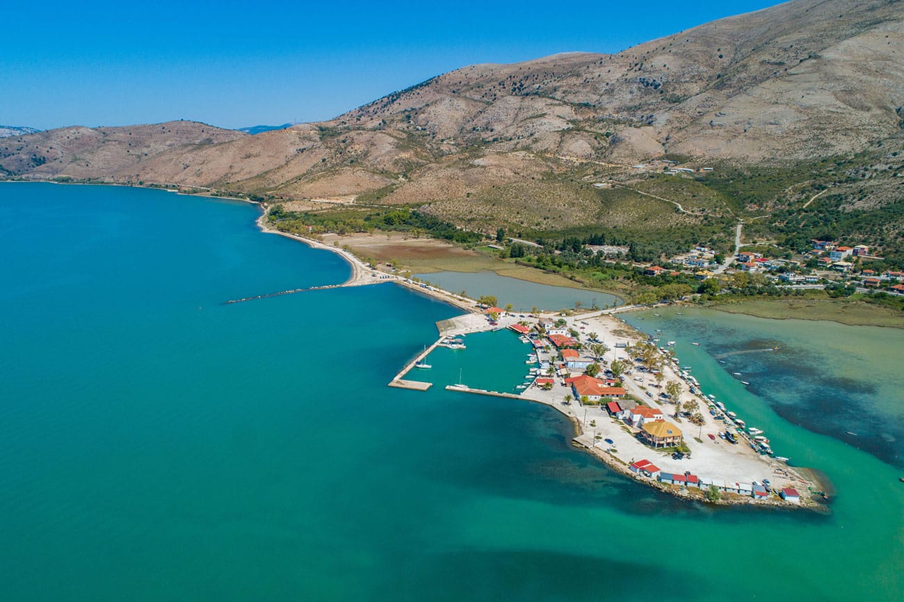 Aerial view of the stunning Corfu coastline showing hidden coves and turquoise waters only accessible by boat